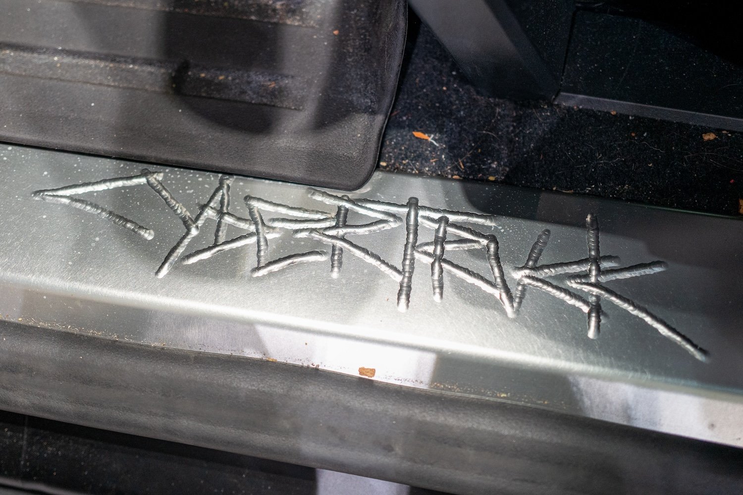 Close-up of engraved "Cybertruck" logo on metal trim, San Jose, California, August 3, 2024.