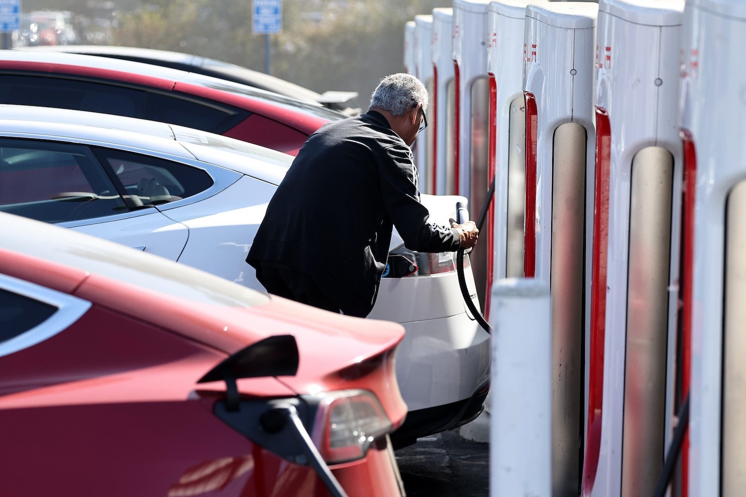 A person recharges a Tesla electric vehicle at a Tesla Supercharger station on September 23, 2024 in Pasadena, California.