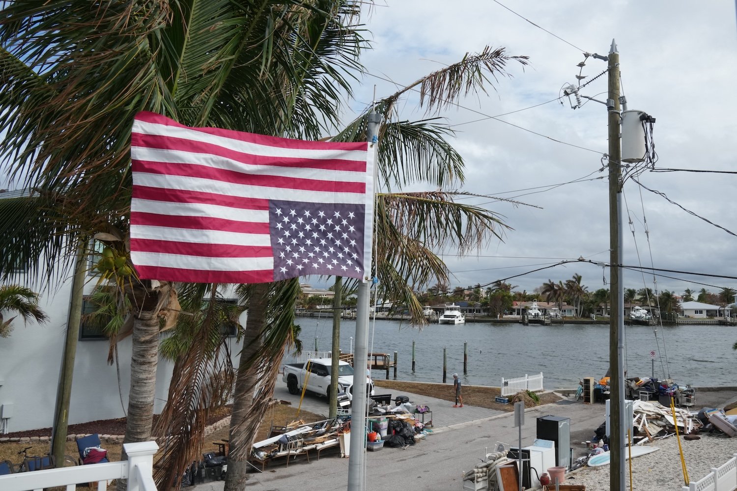 An American flag flies upside down, the international sign for distress, at a home ahead of Hurricane Milton's expected landfall in the middle of this week in Treasure Island, Florida on October 7, 2024.